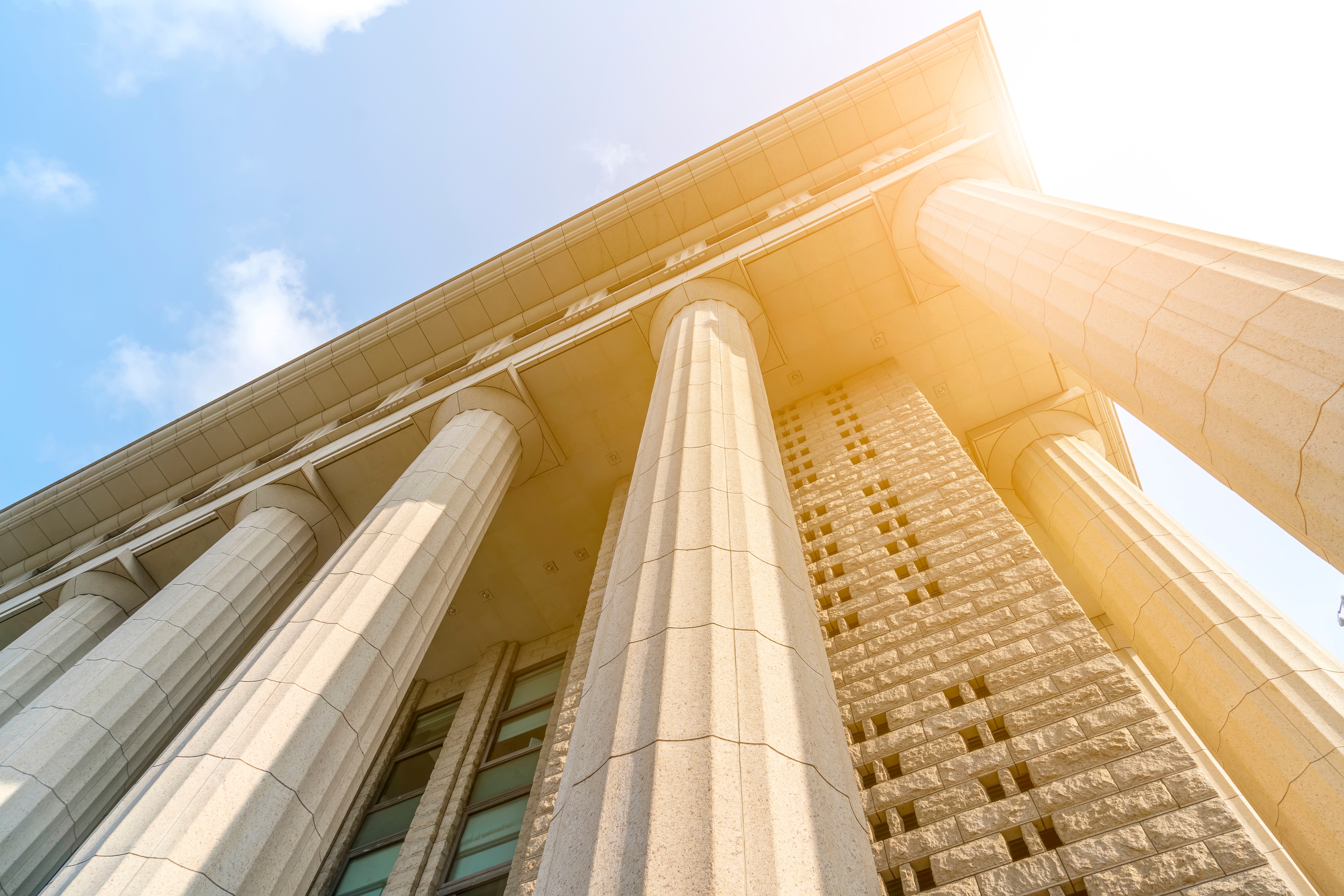 Courthouse pillars representing justice and compliance